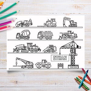 May include: Black and white line drawing of various construction vehicles, including a backhoe loader, bulldozer, excavator, concrete mixer, dump truck, and wheel loader. The name "ETHAN" is printed on the page. Crayons are scattered around the image.