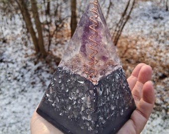 CLEAR INTUITION - a powerful and vibrant nubian orgonite pyramid holdingt and embracing the energy of the amethyst.