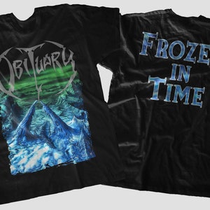 May include: Black t-shirt with a graphic of the band Obituary and the album title "Frozen in Time" on the back.