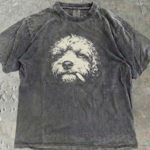 May include: A charcoal gray t-shirt featuring a white graphic of a dog with a cigarette in its mouth. The dog's face is detailed with fur and a serious expression. The shirt has a vintage, washed appearance.