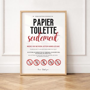 May include: A framed sign with black and red text on a white background. The text reads PAPIER TOILETTE seulement, MERCI DE NE RIEN JETER DANS LES WC, and PLEASE DO NOT FLUSH ANYTHING DOWN THE TOILET, with five red circular icons showing prohibited items.