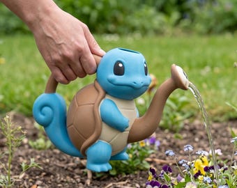 May include: A blue and brown Squirtle-shaped watering can, with water pouring from the spout. The watering can is held over a flower bed with colorful flowers. The can has a blue body, brown shell, and a brown spout.