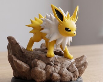 May include: A yellow and white Jolteon figurine stands on a brown, rocky base. The figurine has a spiky mane and tail, with black accents on its ears and eyes. The base is round and black.