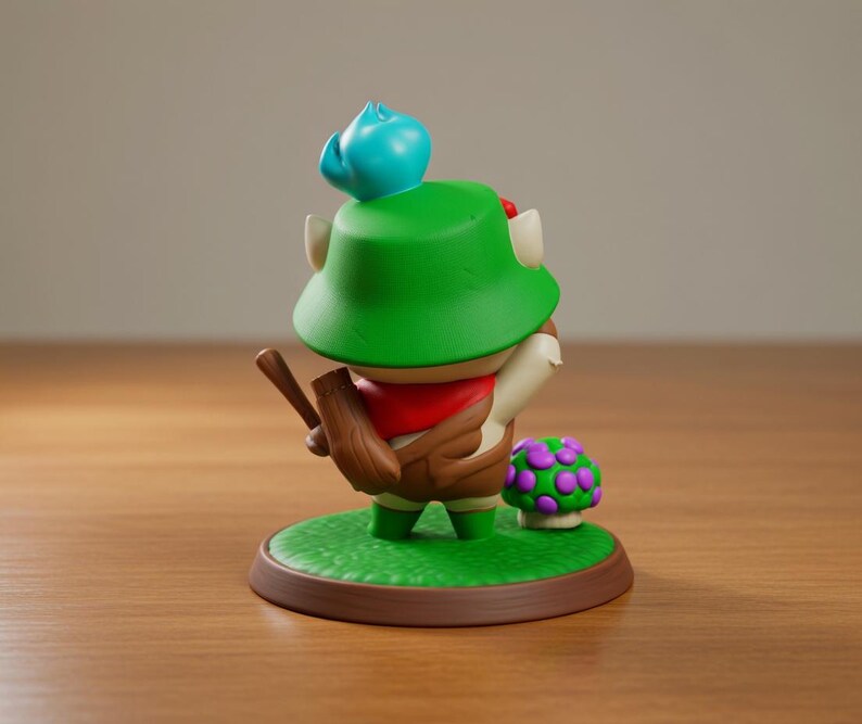 May include: A figurine of a character wearing a green hat, red scarf, and brown outfit, holding a wooden object. The figure stands on a green base with a mushroom and a brown border. A blue object sits atop the hat.
