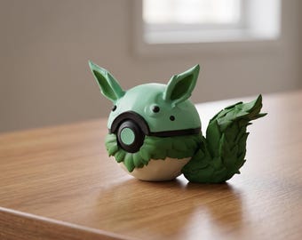 May include: A handcrafted, whimsical sculpture of a creature with a round, mint-green head, large ears, and a leafy tail. The sculpture has a black band around the middle and a green and white body, resting on a wooden surface.
