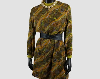 May include: A vintage-style dress with a paisley pattern in shades of brown, orange, and purple. The dress features long sleeves, a high neckline, and a black belt cinching the waist. A pearl necklace and black gloves complete the look.