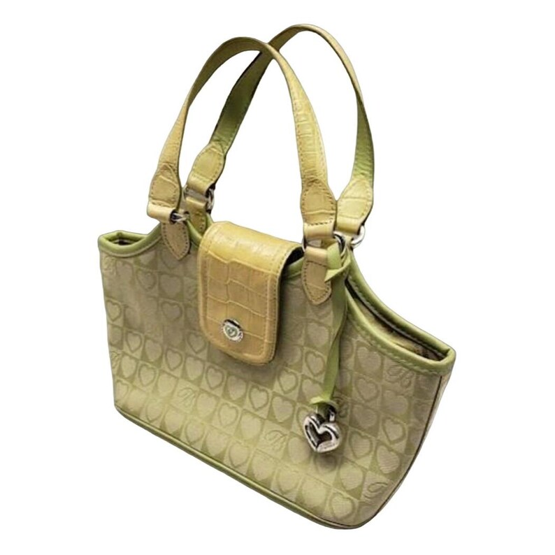 May include: A light green and tan tote bag with a heart pattern and a silver charm. The bag has two top handles and a flap closure.
