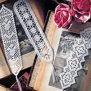 May include: Three white crocheted bookmarks with intricate patterns. The bookmarks are laid out on a book with a vintage floral design. The bookmarks have tassels at the bottom.