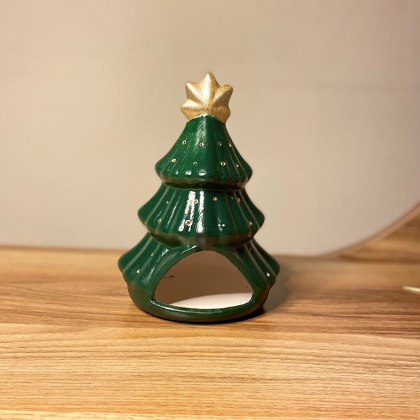Wooden tree trunk candle holder with pinecones and greenery