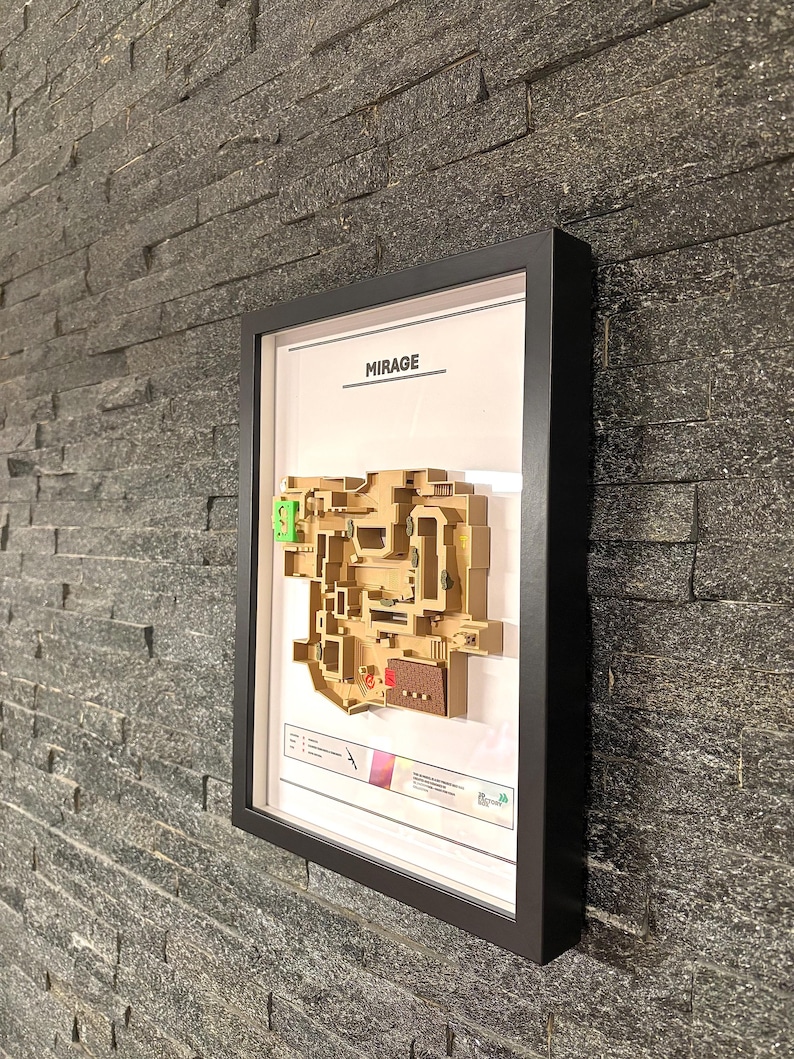 May include: A framed map of the Mirage map from the video game Counter-Strike: Global Offensive. The map is printed in brown and green on a white background. The frame is black and has a white mat.