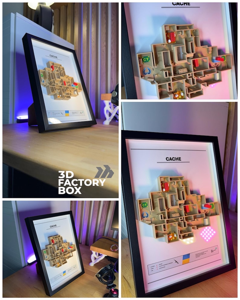 May include: A framed 3D map of the "Cache" level from a video game, with a black frame. The map is a detailed, multi-layered model with various colored zones and text labels. The frame is displayed on a wooden surface.