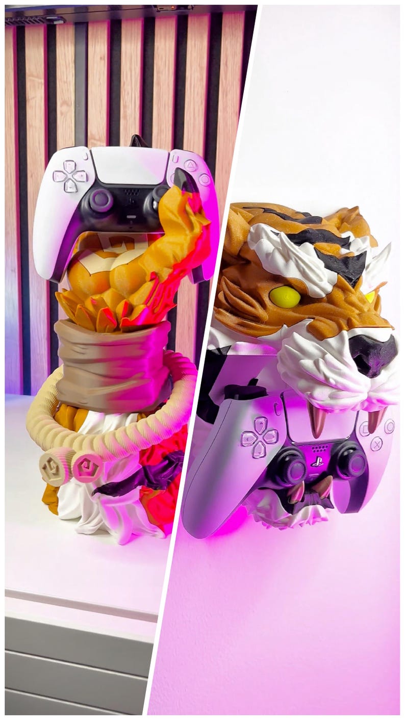 May include: A white and black PlayStation 5 controller rests on a decorative tiger head stand. The stand features a detailed tiger head with orange, brown, and white fur, and yellow eyes. The stand has a beige rope-like design.