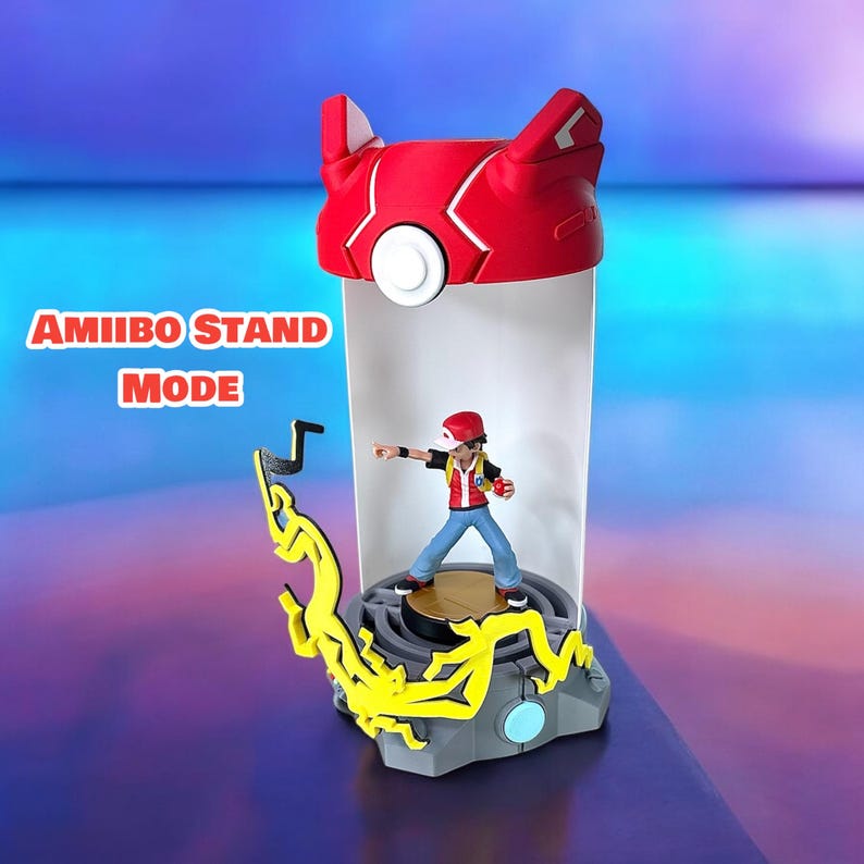 May include: A red and white Pokemon Amiibo stand in "Amiibo Stand Mode" with a figure of a Pokemon trainer inside. The stand has a yellow lightning bolt design on the base.
