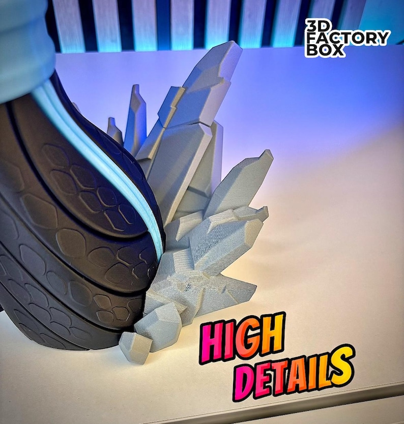 May include: A close-up of a 3D-printed sculpture with high detail. The sculpture features a dark gray, textured section with a light blue accent, and a light gray, crystalline structure. The words "HIGH DETAILS" are in a colorful, outlined font.