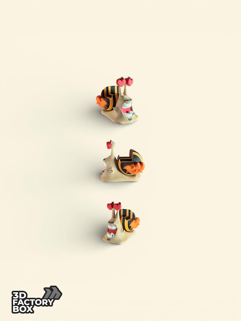 May include: Three whimsical snail figurines with beige bodies, black and yellow striped shells, and orange accents. Each snail has red heart-shaped antennae and a smiling mouth. The logo "3D FACTORY BOX" is in the lower left corner.