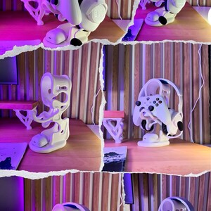 Peut inclure: Support de casque et de manette de jeu imprim&eacute; en 3D, de couleur blanche. Il maintient un casque JBL blanc et une manette Xbox blanche. Sur une surface en bois avec un fond violet et rose. Le texte "3D FACTORY BOX" est visible.