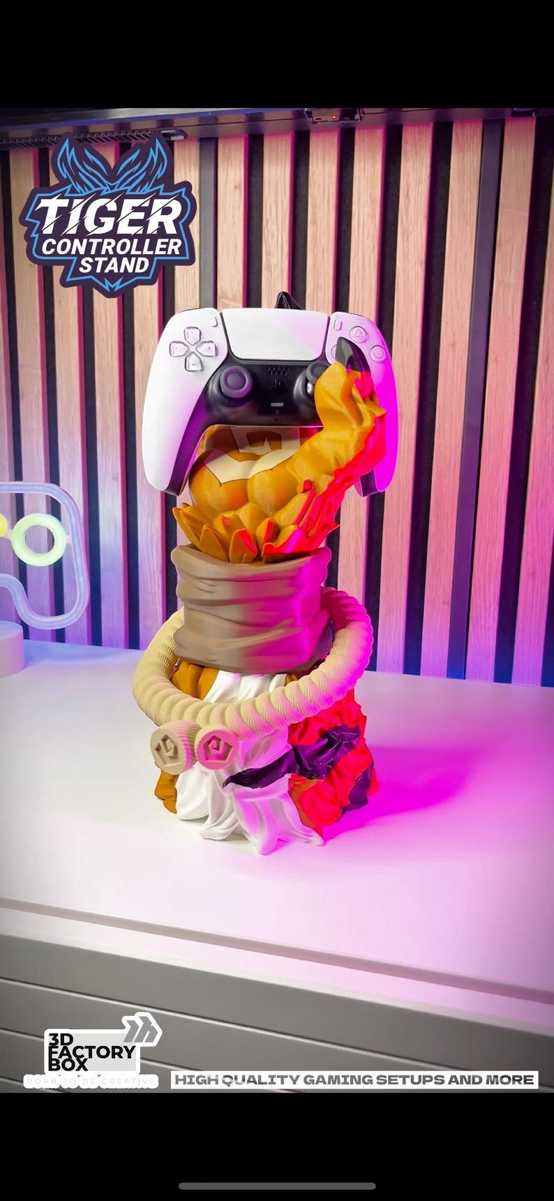 May include: A white and black PlayStation 5 controller stand with a tiger design. The stand has a detailed tiger head and body, with a white controller resting on top. The stand has the text "TIGER CONTROLLER STAND".