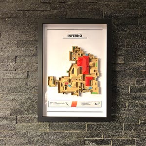 May include: A framed map of the "Inferno" map from the video game Counter-Strike: Global Offensive. The map is a detailed, 3D representation of the layout of the map, with different areas and locations labeled.
