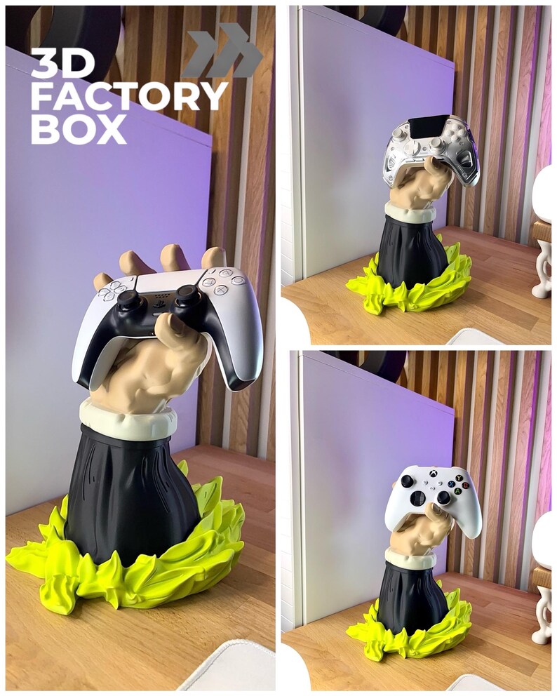 Op de afbeelding: Een 3D-geprinte sculptuur van een hand die een videogamecontroller vasthoudt. De hand is bevestigd aan een zwarte basis met een witte kraag, omgeven door een heldergroen, bladerachtig ontwerp. De tekst "3D FACTORY BOX" staat in de linkerbovenhoek.