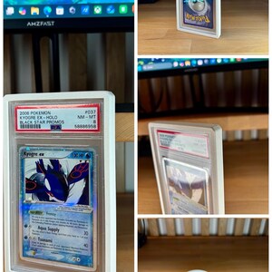 May include: A white 3D-printed protective case for a Pok&eacute;mon trading card. The card features Kyogre ex from the Black Star Promos series. The case is designed to hold and display the card, with the text "3D FACTORY BOX" visible.