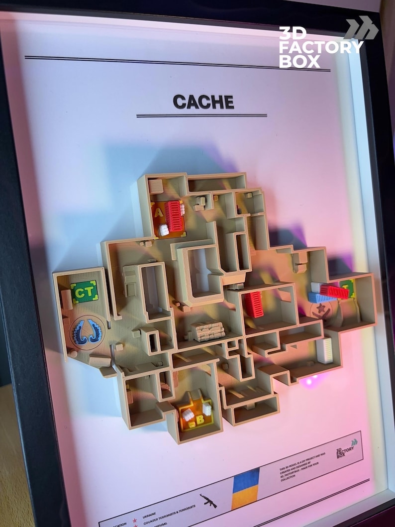 May include: A framed 3D model of a map labeled "CACHE". The model is beige with red and blue accents, depicting a complex layout with various rooms and pathways. The frame includes the text "3D FACTORY BOX".