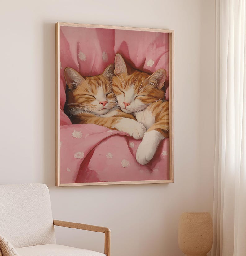 Op de afbeelding: Twee oranje tabby-katten knuffelen en slapen in een roze deken met witte stippen.