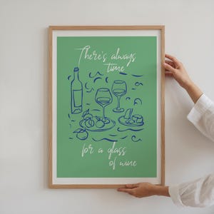 Peut inclure: Une affiche verte avec une illustration bleue d'une bouteille de vin, deux verres de vin et une assiette de fromage et de fruits. Le texte sur l'affiche dit "Il y a toujours le temps pour un verre de vin."