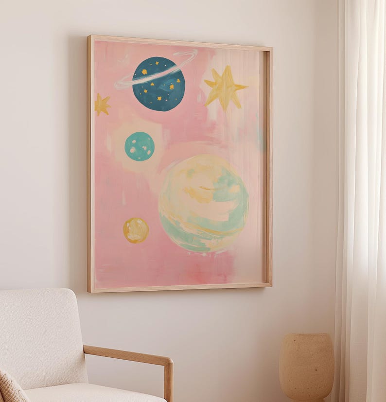 May include: A framed painting of a pink sky with blue, green, and yellow planets and stars. The planets have a watercolor effect.