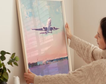 Puede incluir: Una pintura enmarcada de un avión blanco despegando contra un cielo colorido con tonos rosados, azules y morados. El avión está enfocado, mientras que el fondo está desenfocado.