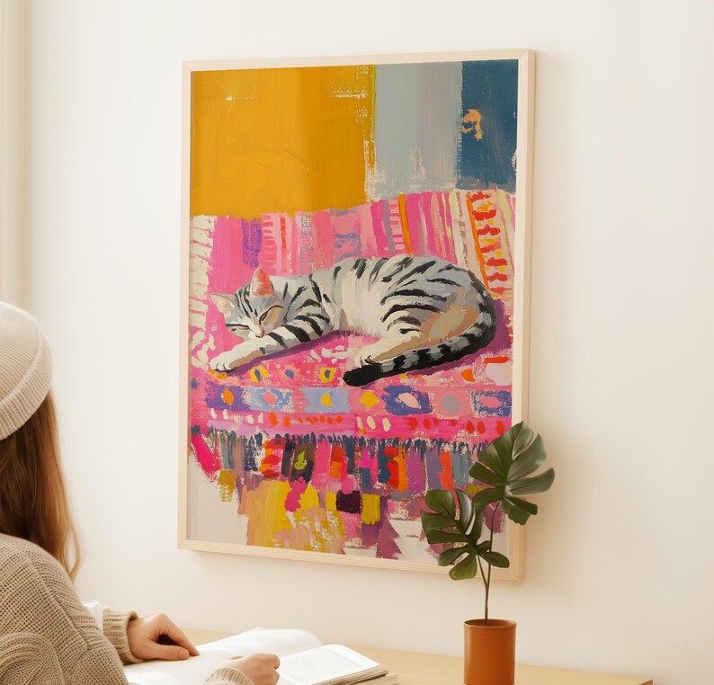 May include: A painting of a gray and white tabby cat sleeping on a colorful pink, yellow, and blue patterned rug.
