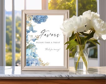 May include: A white sign with a gold frame and blue hydrangea flowers. The sign says "Favors Please Take A Treat Thanks for coming!"