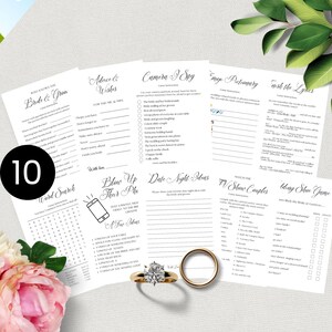 May include: Ten white printed wedding game sheets with activities like "Who Knows the Bride & Groom" and "Word Search." A gold engagement ring and wedding band are in the foreground. A pink flower is in the lower left.