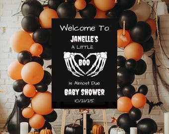 Pode incluir: Uma placa de chá de bebê com tema de Halloween com o texto "Welcome To Janelle's A Little Boo Is Almost Due BABY SHOWER 10/21/25". A placa é cercada por balões laranja e pretos, abóboras e velas.
