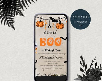 May include: A smartphone displaying a digital Halloween-themed baby shower invitation with the text A LITTLE BOO IS ALMOST DUE, featuring orange pumpkins, black bats, and stars on a light background, with a circular badge labelled ANIMATED DOWNLOAD.
