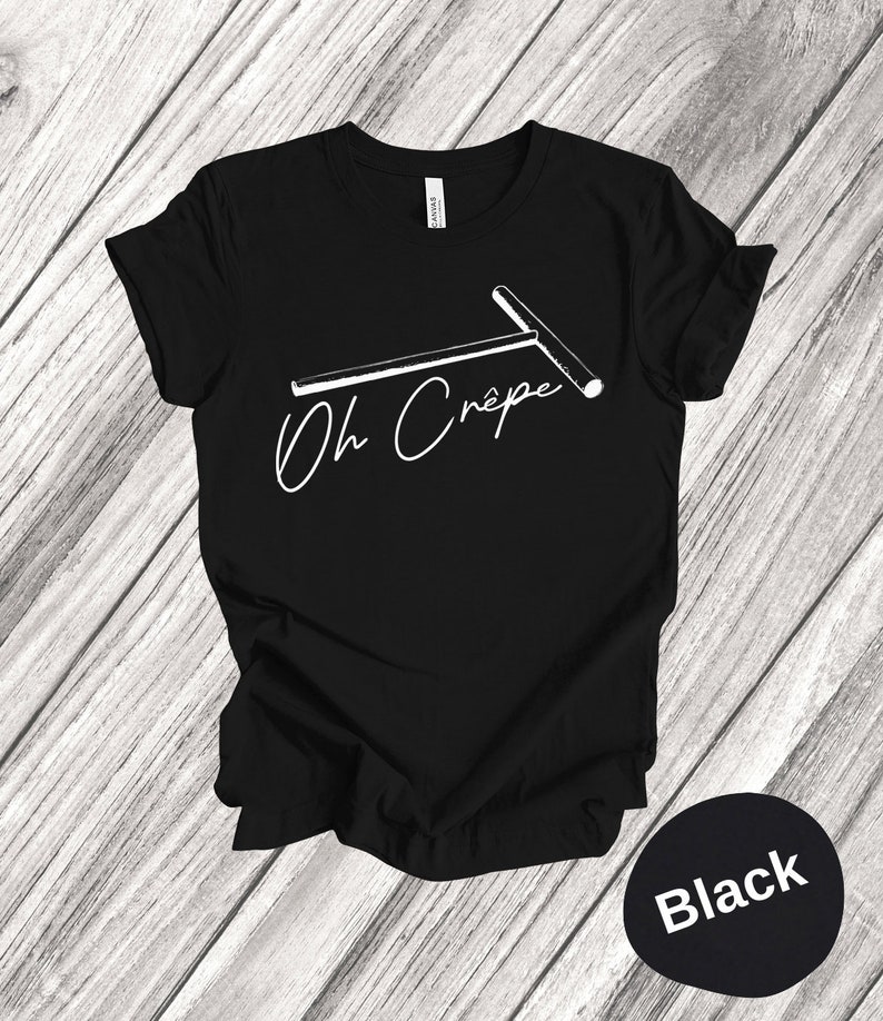 May include: Black t-shirt with a white graphic of a crepe maker and the text "Oh Crepe".