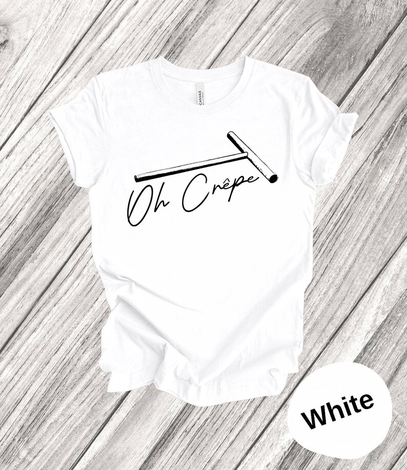 May include: White t-shirt with a black and white illustration of a crepe maker and the text "Oh Cr&ecirc;pe".
