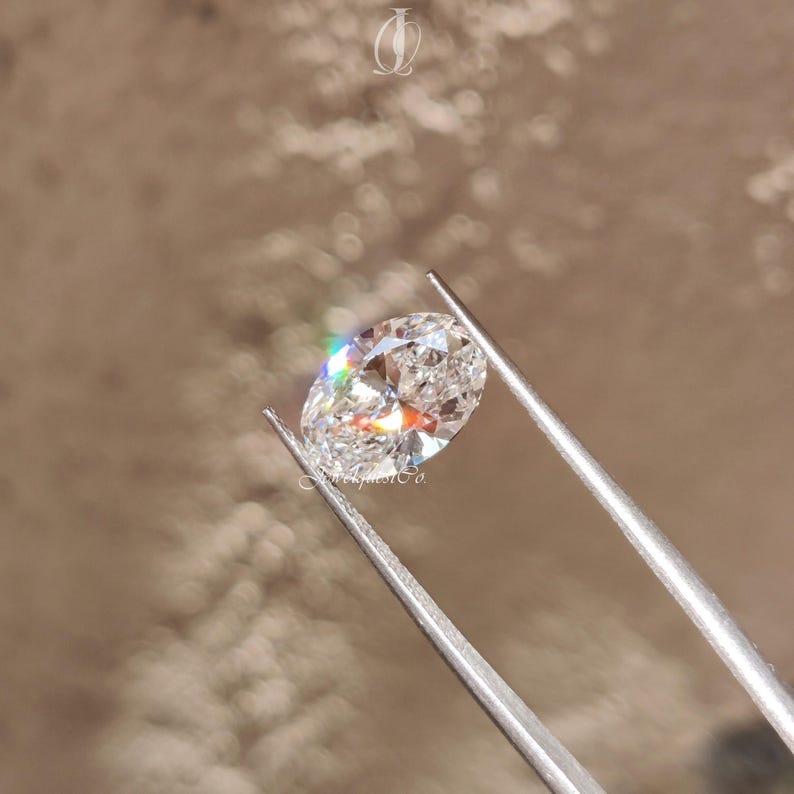 Close-up view of a loose oval-shaped lab-grown diamond resting on a velvet ring box, designed to showcase its flawless facets and sustainable origin. Perfect stone for jewelers and ethical shoppers.