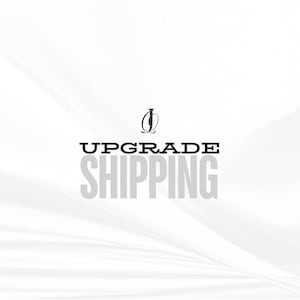 May include: White background with a black and white logo and the text "UPGRADE SHIPPING" in black.