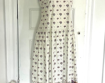 Vintage drop waist sundress made from French oulivado fabric by the Red Mill Collection in white with dots and border trim.
