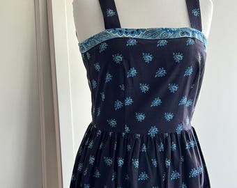 Vintage fitted sundress sewn  from French oulivado fabric in black  with border trim made in the USA by The Red Mill Collection .