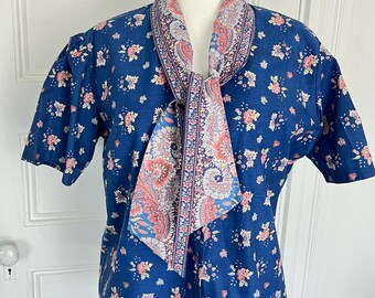 French Vintage Oulivado fabric sewn into a blouse by Red Mill Collection. Oulivado fabric is a royal blue print with peach flowers. size 14