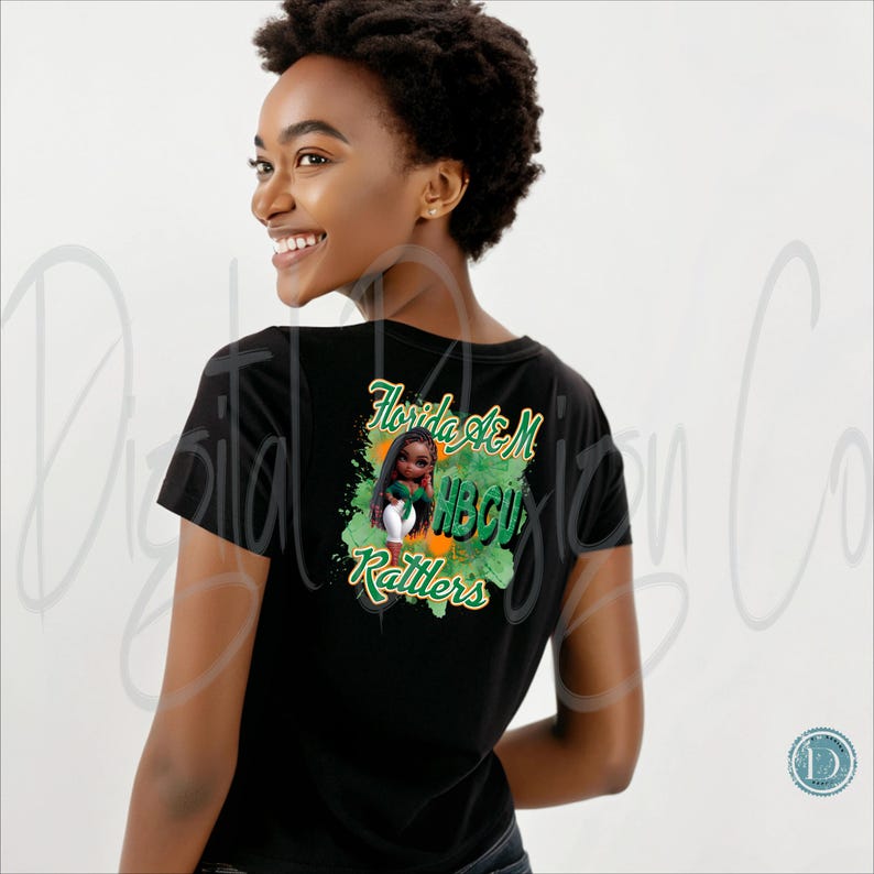 May include: Black t-shirt with a graphic on the back featuring a cartoon girl in a green and white outfit, with the text "Florida A&M HBCU Rattlers" in green and orange.