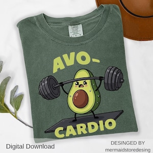 May include: Green t-shirt with the text "AVO-CARDIO" and a cartoon avocado lifting weights. The shirt is a Comfort Colors brand, and the design is by mermaidstoredesing. The words "Digital Download" are also visible.