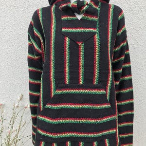 May include: Black and red striped hooded poncho with green and yellow stripes. The poncho has a large pocket on the front.