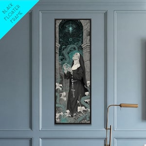May include: A vertical rectangular wall art piece in a black floater frame depicting a nun in a black habit and white wimple standing amidst swirling teal vines and white lilies. Above, a glowing teal light shines from a dark stone archway.