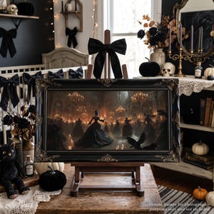 May include: A rectangular painting in an ornate black frame with gold accents, displayed on a wooden easel topped with a black fabric bow. The artwork depicts a grand ballroom scene with figures in dark gowns, glowing chandeliers, and black birds.