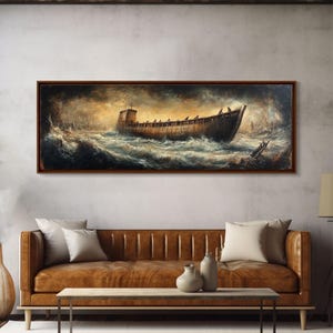May include: A framed painting depicts a wooden ship navigating turbulent waters under a stormy sky. The artwork features a dark color palette with shades of brown, gray, and blue, creating a dramatic and evocative scene. The painting is displayed above a brown leather sofa.