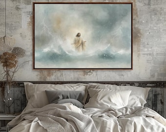 May include: A framed canvas art print depicts a figure in a white robe amidst stormy waves and lightning. The artwork has a soft, ethereal quality with a muted color palette of blues, whites, and browns. The frame is a dark brown color.