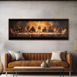May include: A framed print of "The Last Supper" depicting Jesus and his disciples at a table. The artwork features warm tones and detailed figures. The frame is dark brown, and the print is displayed above a brown leather sofa.