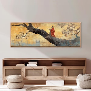 May include: A framed artwork depicts a figure in red robes with a halo, perched on a tree branch against a gold and blue background. The artwork is in a rectangular wooden frame, suitable for wall decor. The style is reminiscent of religious art.